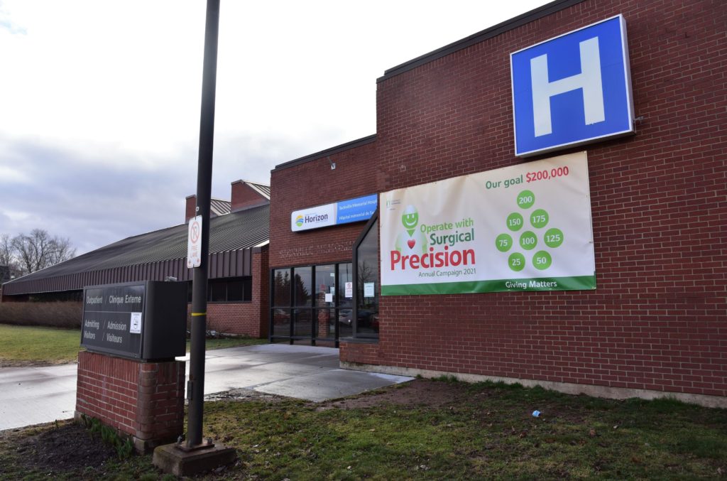 The Sackville Memorial Hospital entrance in the daytime. There is a sign on the front advertising for a fundraiser.