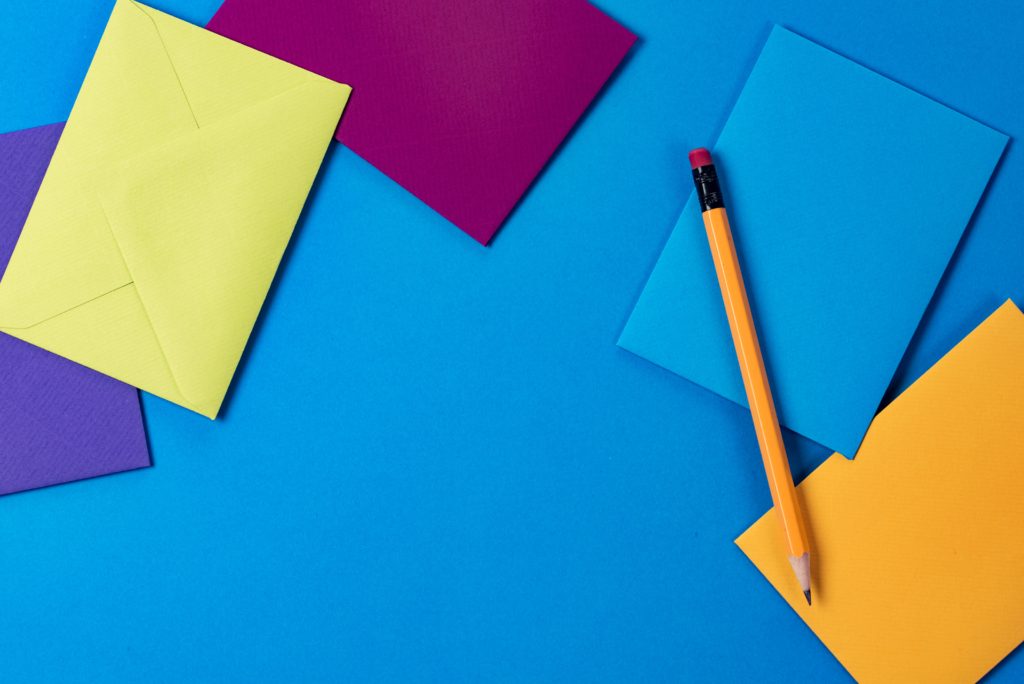 A photo of envelopes and a pencil.