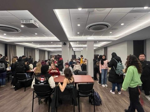 International students gathered together for a potluck with a cause