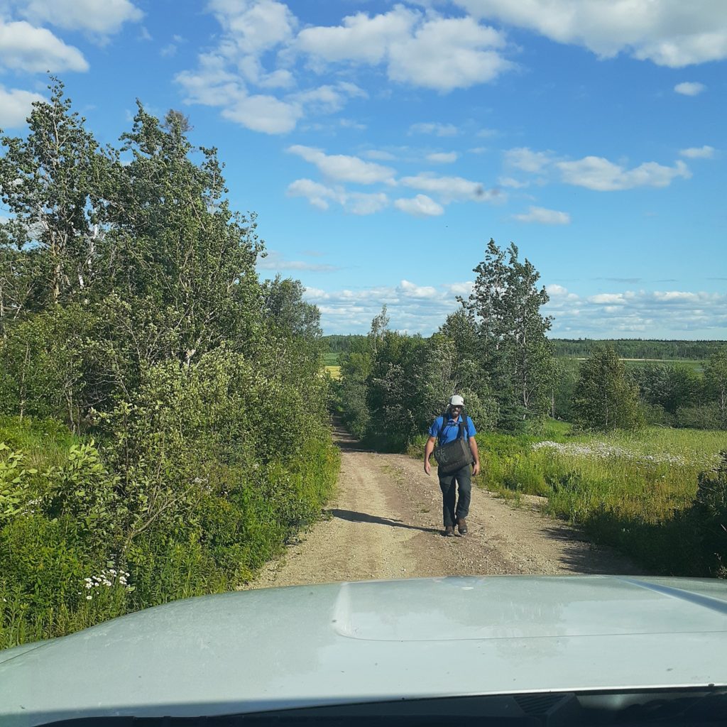 Rory Fraser walks on a dirt road outside.