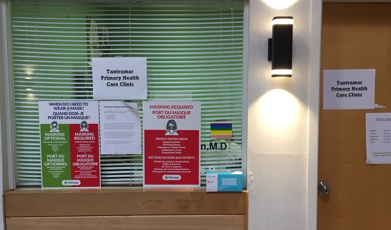 An office window with blinds closed and signs posted to the glass reading "Tantramar Primary Health Care Clinic"